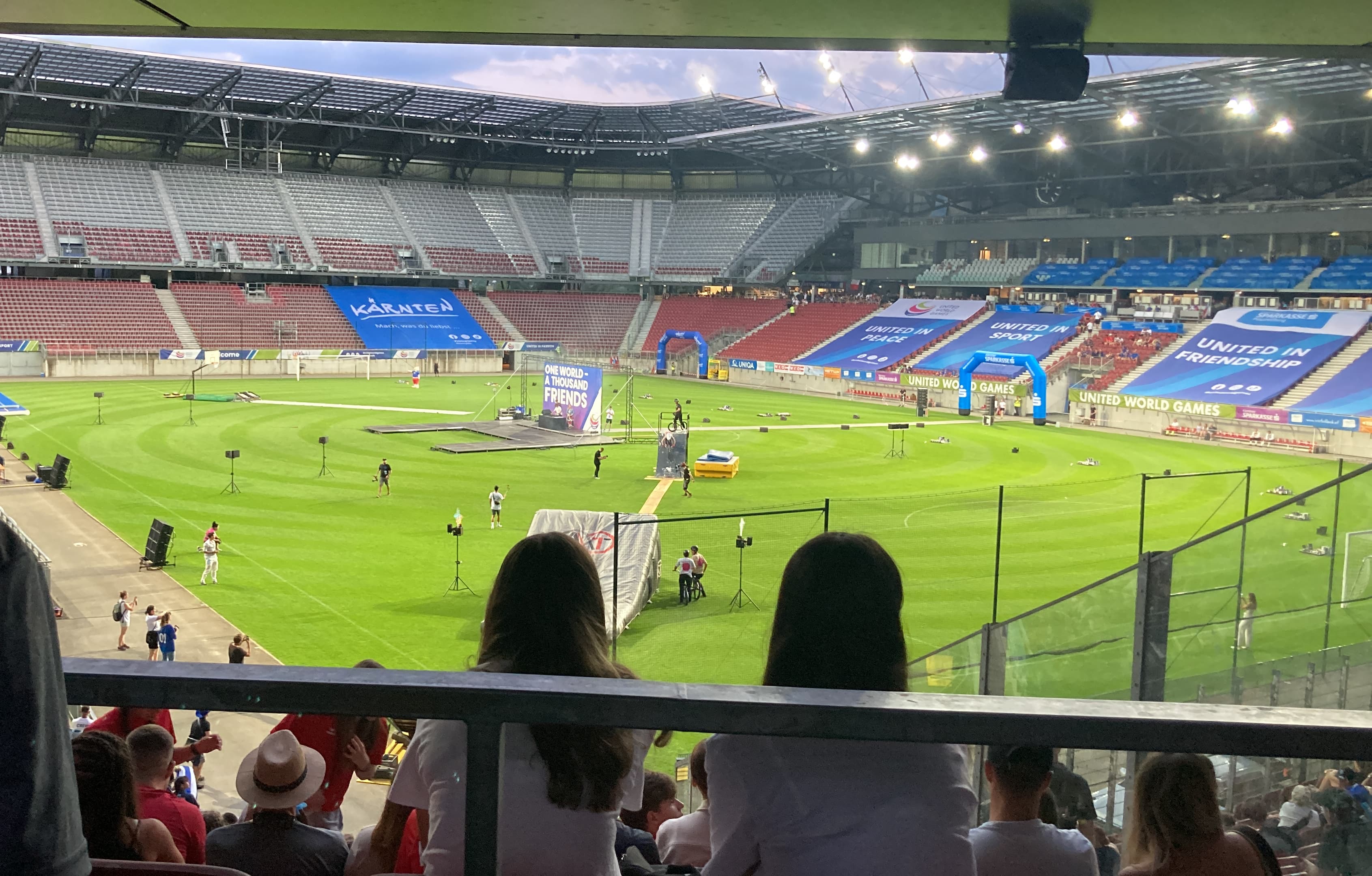 View from the stands of the Wörthersee Stadium in Klagenfurt during the United World Games, featuring a large soccer field with event banners.