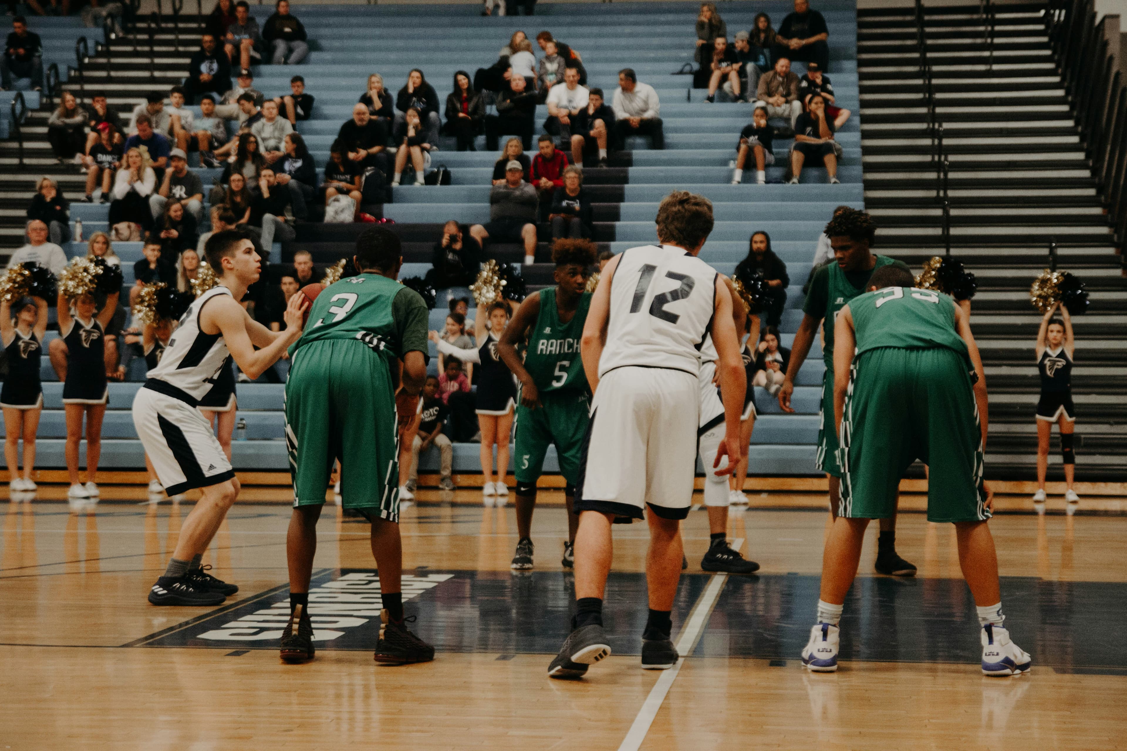 High school basketball players competing in gym
