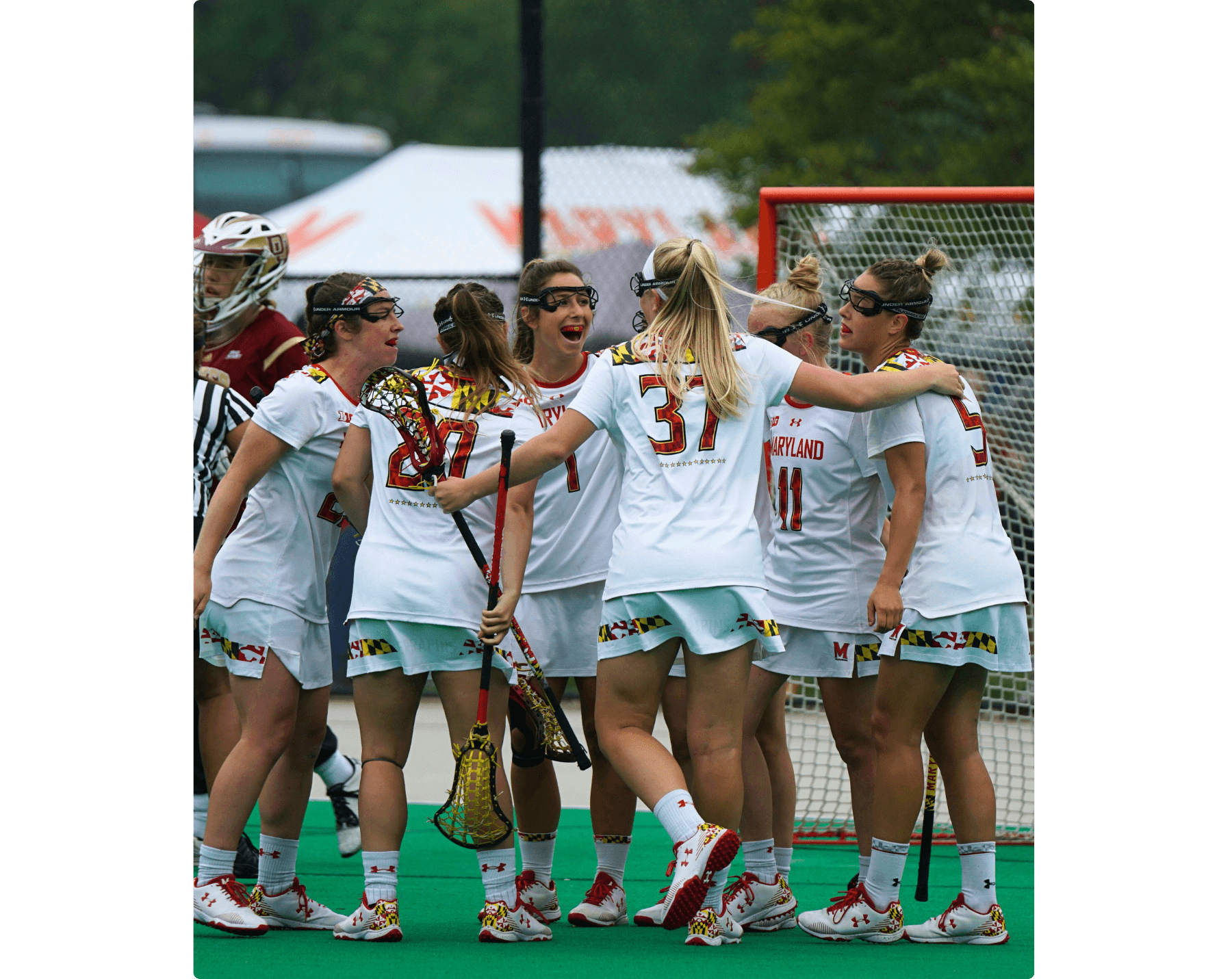 The Terrapins scored against the Denver Pioneers and 6 players celebrate. University of Maryland women's lacrosse squad celebrates.