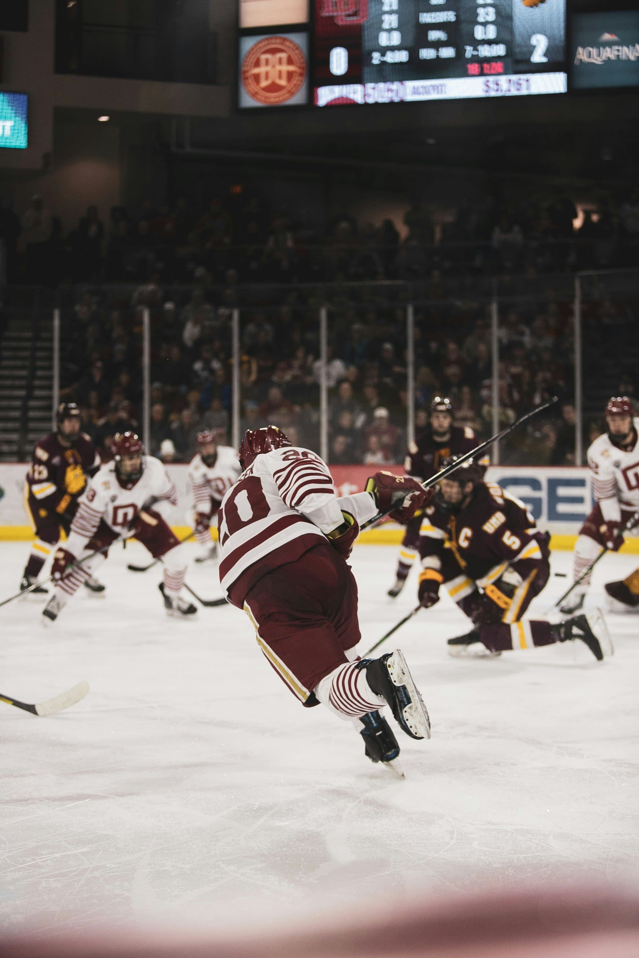 Logan Weaver - College Ice Hockey Player Logan Weaver, college ice hockey player, competing on the ice rink during a game.