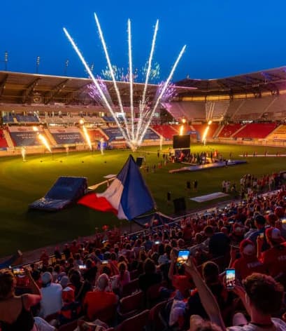 United World Games Night Ceremony with Fireworks Nighttime ceremony at United World Games with fireworks and a cheering crowd in a large stadium.