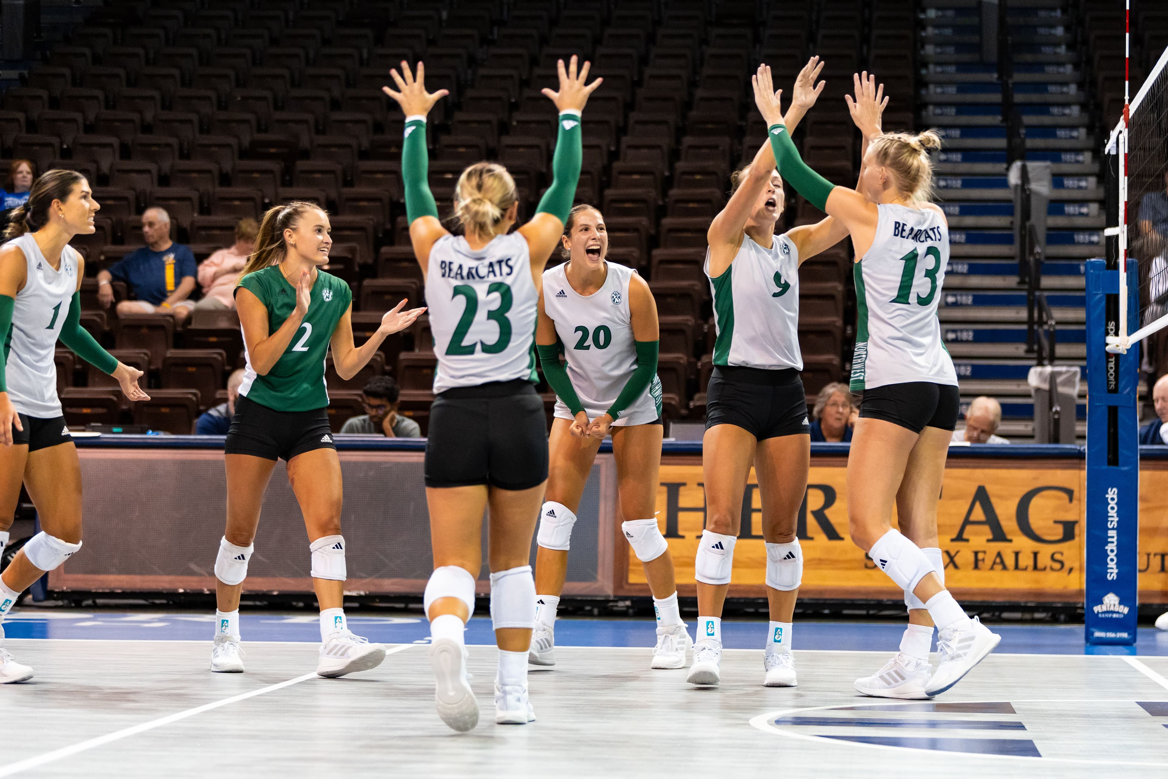 College volleyball players celebrating a point on the court